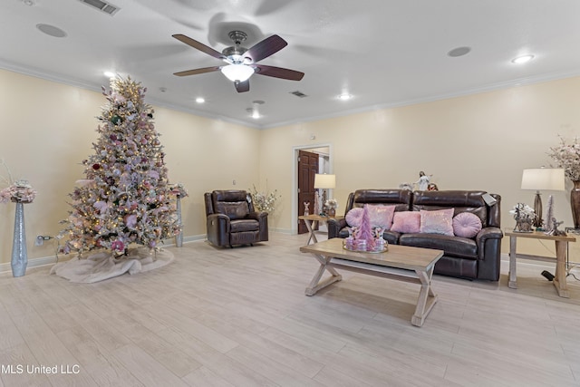 living room with light hardwood / wood-style floors, ceiling fan, and crown molding