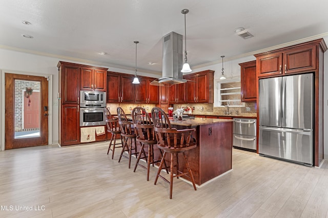 kitchen featuring light stone countertops, stainless steel appliances, island exhaust hood, a breakfast bar, and a kitchen island