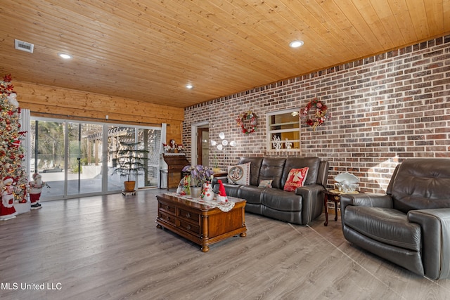 living room featuring light hardwood / wood-style flooring, wooden ceiling, and brick wall