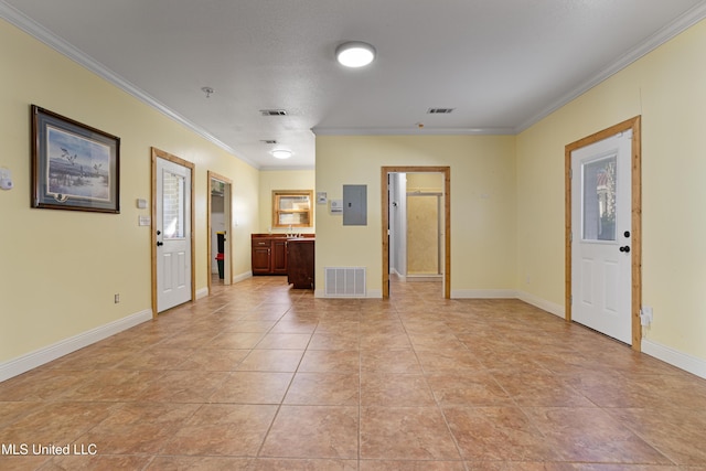 tiled foyer with electric panel and crown molding