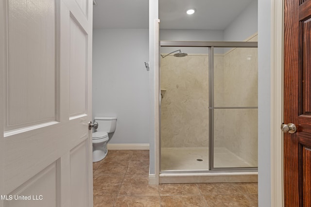 bathroom with toilet and an enclosed shower