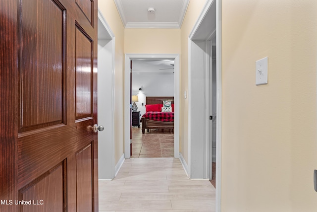 hallway featuring light hardwood / wood-style floors and ornamental molding