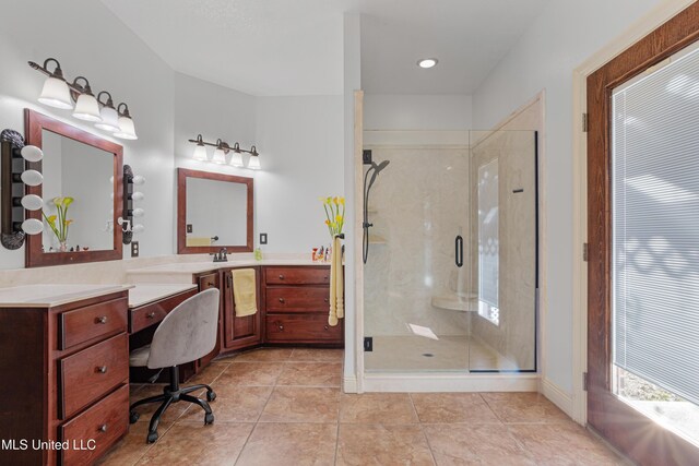 bathroom featuring tile patterned flooring, vanity, and a shower with shower door