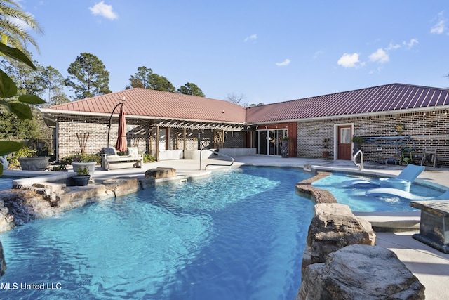 view of pool featuring a jacuzzi and a patio area