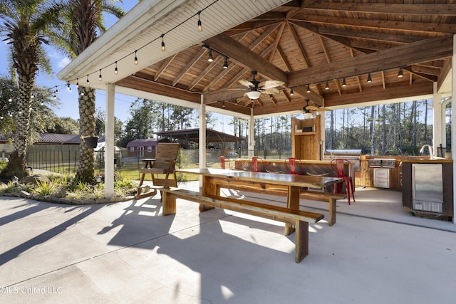 view of patio featuring a gazebo, area for grilling, ceiling fan, and sink