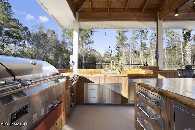 view of patio / terrace with exterior kitchen, sink, and grilling area