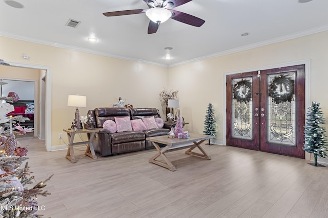 living room featuring french doors, light hardwood / wood-style flooring, and ornamental molding