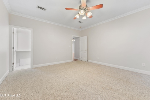 carpeted spare room with ceiling fan and crown molding