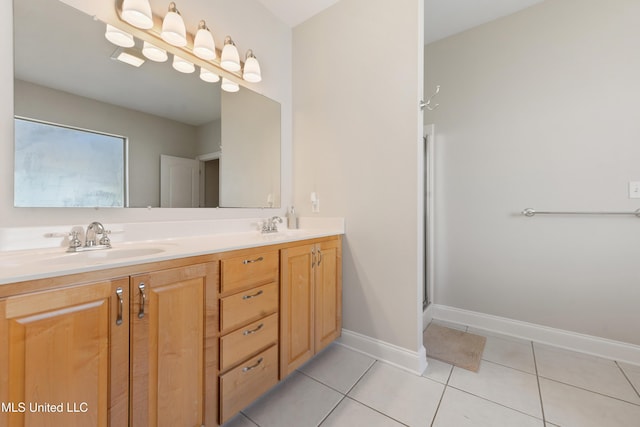 bathroom with tile patterned flooring, a shower with door, and vanity