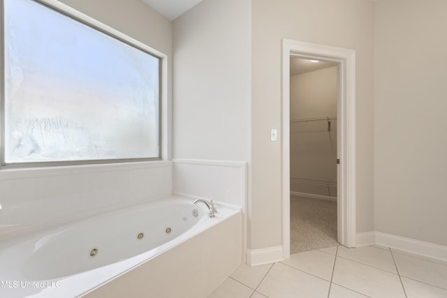 bathroom with a bathtub and tile patterned floors