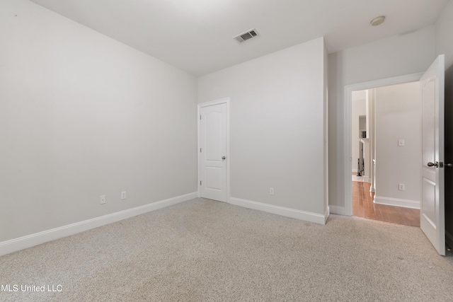 unfurnished bedroom with light colored carpet