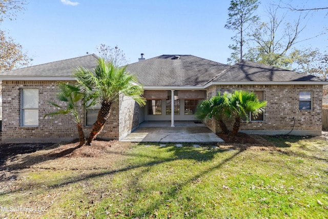 back of property featuring a patio area and a yard