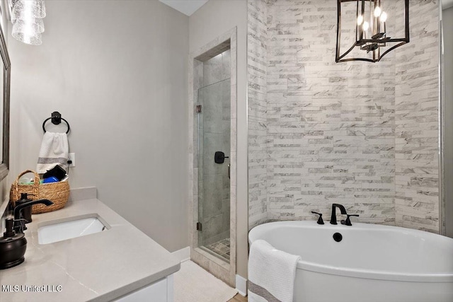 bathroom with a stall shower, a freestanding tub, and vanity