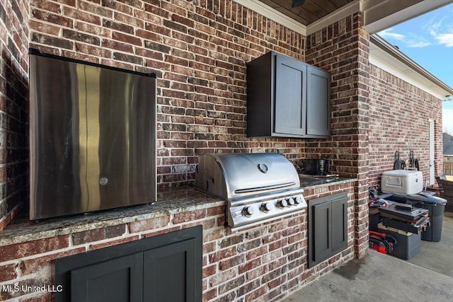 view of patio / terrace featuring grilling area and an outdoor kitchen