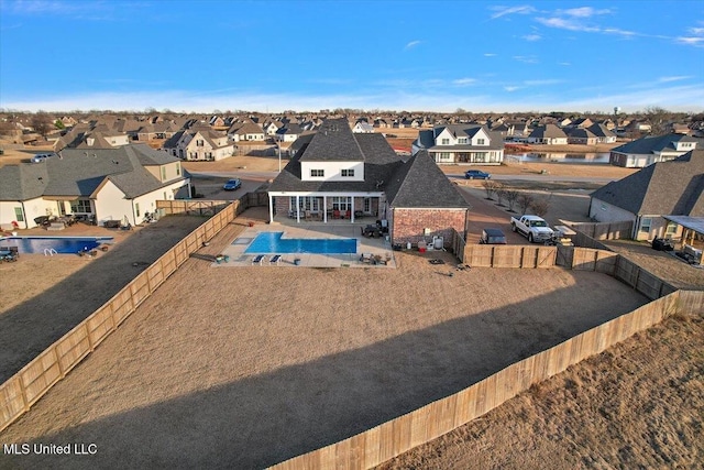 view of swimming pool with a patio, a fenced backyard, a residential view, and a fenced in pool