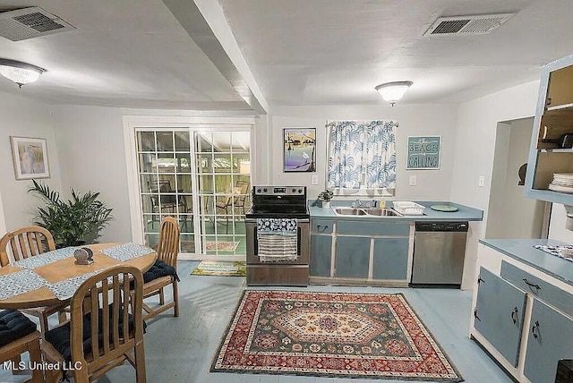 kitchen with appliances with stainless steel finishes, sink, and gray cabinetry