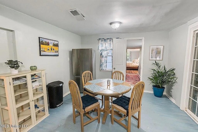 dining space with concrete flooring