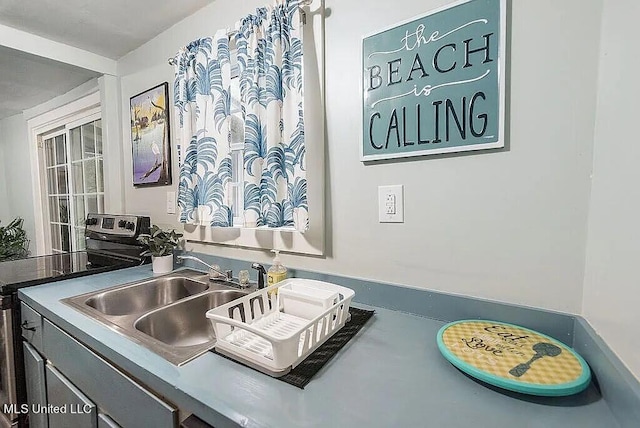 kitchen with stainless steel electric stove and sink