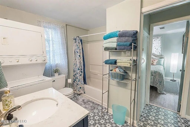 full bathroom featuring vanity, shower / tub combo, stacked washer / dryer, and toilet