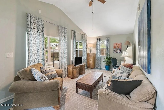 living area with ceiling fan, hardwood / wood-style flooring, and vaulted ceiling