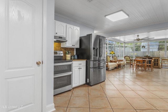 9000 Spring Ave, Ocean Springs, MS 39564 - kitchen with light tile patterned floors, appliances with stainless steel finishes, under cabinet range hood, and white cabinetry