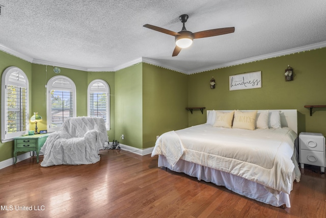 9000 Spring Ave, Ocean Springs, MS 39564 - bedroom with crown molding, wood finished floors, baseboards, a textured ceiling, and a ceiling fan