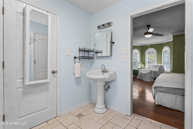 9000 Spring Ave, Ocean Springs, MS 39564 - ensuite bathroom with ceiling fan, a textured ceiling, tile patterned flooring, baseboards, and ensuite bathroom