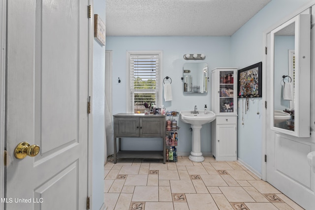 9000 Spring Ave, Ocean Springs, MS 39564 - bathroom featuring a textured ceiling and baseboards