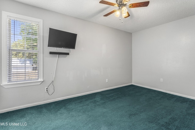 9000 Spring Ave, Ocean Springs, MS 39564 - empty room with baseboards, ceiling fan, dark colored carpet, and a textured ceiling
