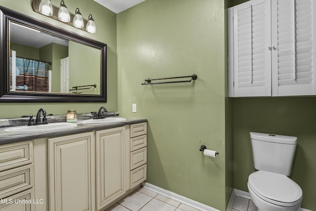 9000 Spring Ave, Ocean Springs, MS 39564 - bathroom featuring tile patterned flooring, a sink, double vanity, and toilet