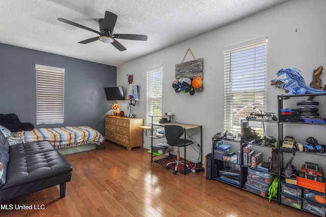 9000 Spring Ave, Ocean Springs, MS 39564 - bedroom featuring a ceiling fan, a textured ceiling, and wood finished floors