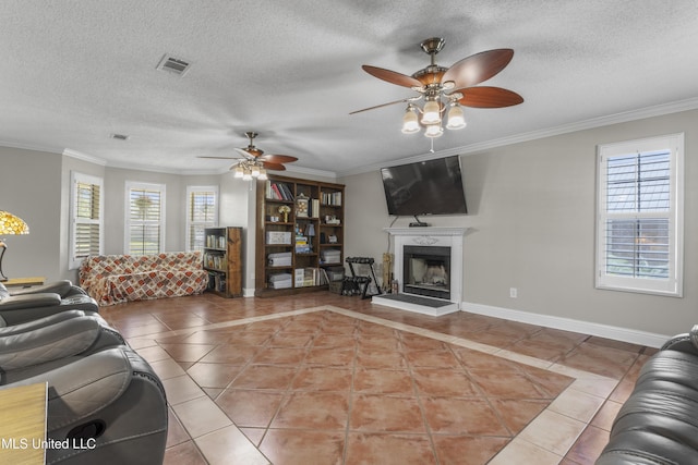 9000 Spring Ave, Ocean Springs, MS 39564 - living area featuring a healthy amount of sunlight, light tile patterned floors, ceiling fan, and visible vents