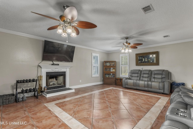 9000 Spring Ave, Ocean Springs, MS 39564 - living area featuring visible vents, a ceiling fan, a textured ceiling, and crown molding