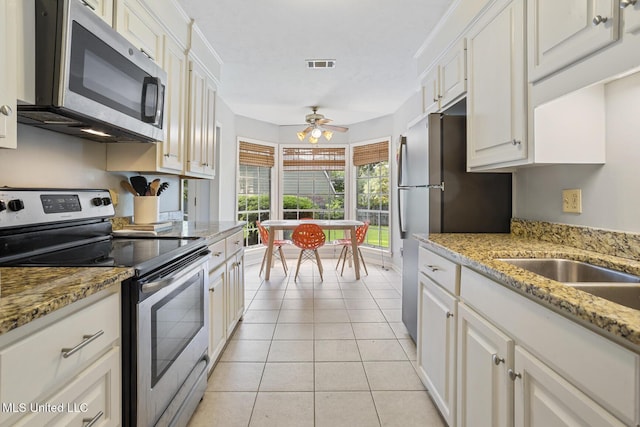 5348 Saratoga Dr, Jackson, MS 39211 - kitchen with appliances with stainless steel finishes, light tile patterned floors, and white cabinetry