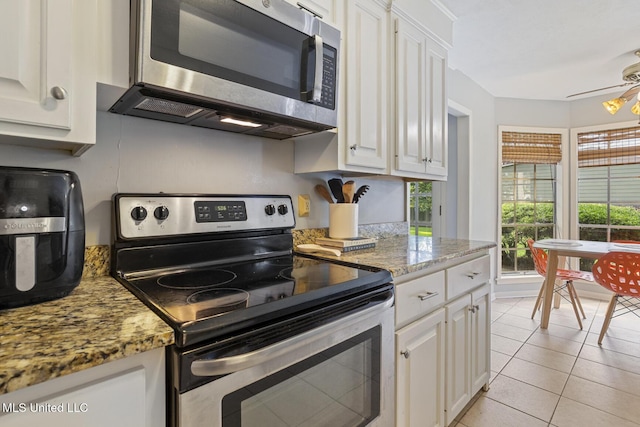 5348 Saratoga Dr, Jackson, MS 39211 - kitchen with appliances with stainless steel finishes, white cabinets, light tile patterned flooring, light stone counters, and a ceiling fan