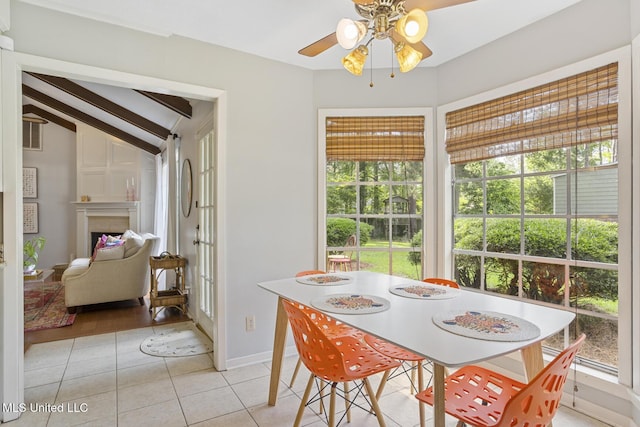 5348 Saratoga Dr, Jackson, MS 39211 - dining room featuring light tile patterned floors, ceiling fan, healthy amount of natural light, lofted ceiling, and a fireplace