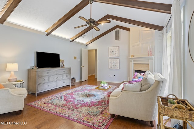 5348 Saratoga Dr, Jackson, MS 39211 - living room featuring a ceiling fan, beamed ceiling, a fireplace, wood finished floors, and baseboards