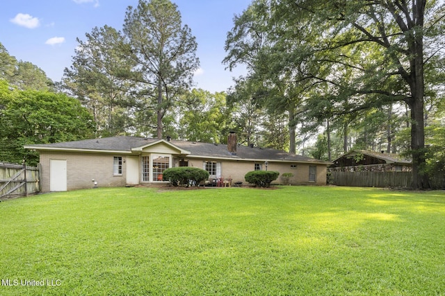 5348 Saratoga Dr, Jackson, MS 39211 - back of house featuring a chimney and brick siding