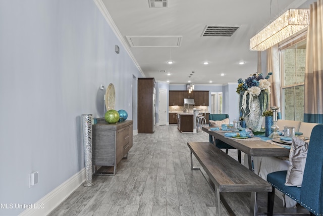 dining space featuring attic access, ornamental molding, light wood-style floors, recessed lighting, and baseboards