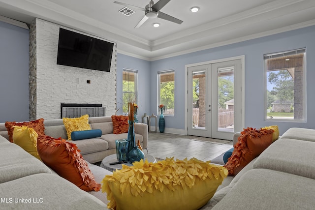 living area with french doors, wood finished floors, a ceiling fan, ornamental molding, and recessed lighting