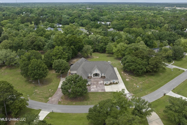 aerial view of property's location with a forest
