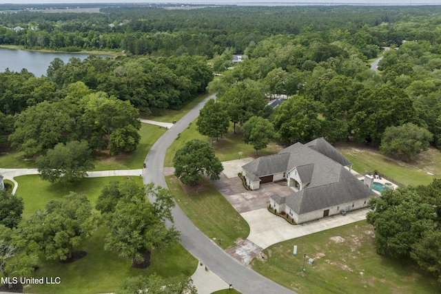 bird's eye view of a heavily wooded area and a nearby body of water