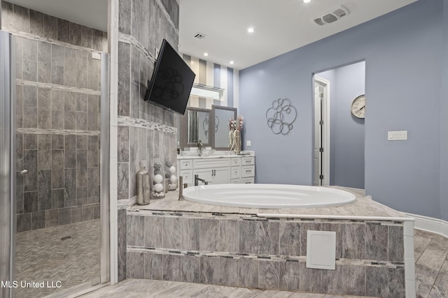 full bath featuring a bath, a tile shower, recessed lighting, and vanity