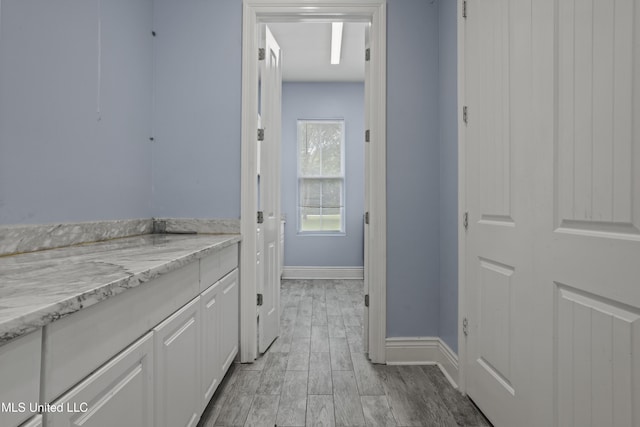 bathroom featuring baseboards and wood finish floors