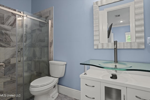 bathroom featuring toilet, a stall shower, baseboards, vanity, and crown molding