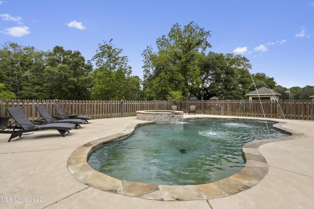 view of swimming pool with a patio, a fenced backyard, and a pool with connected hot tub