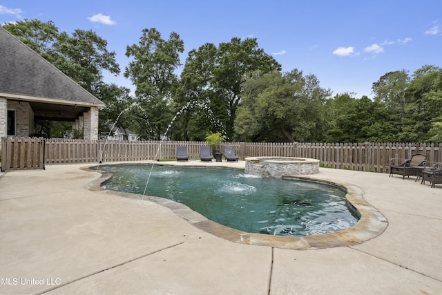 view of pool featuring a patio area, fence, and a pool with connected hot tub