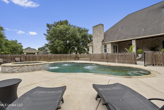 view of swimming pool featuring a fenced backyard, a patio, and a pool with connected hot tub
