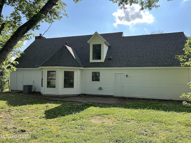 7120 Oak Forest Dr, Olive Branch, MS 38654 - back of house featuring a lawn, roof with shingles, a patio area, and a chimney