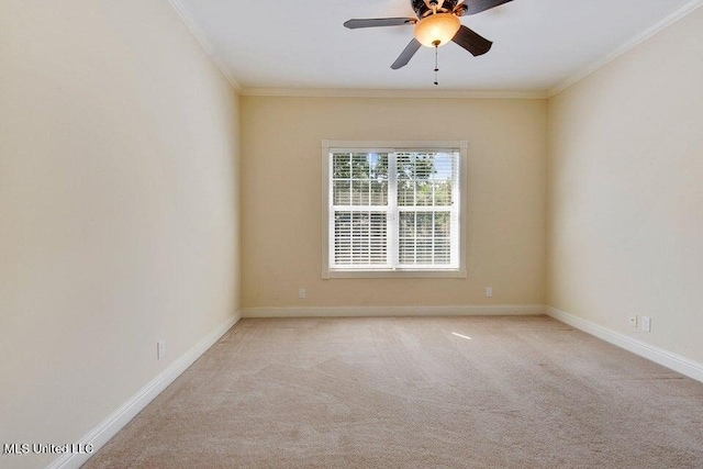 spare room with crown molding, light carpet, and ceiling fan